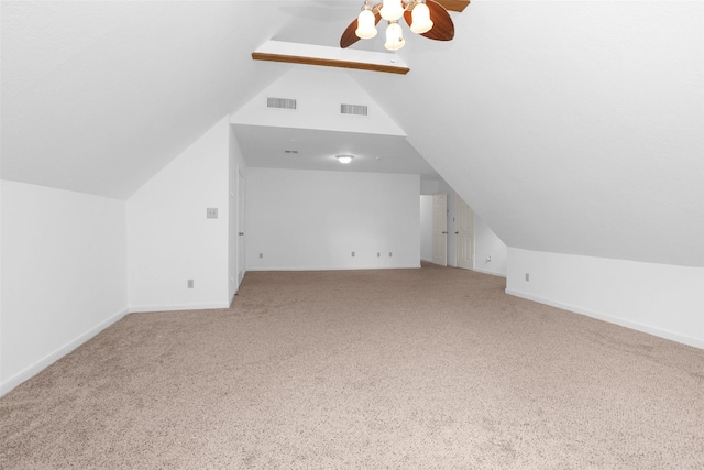 additional living space featuring lofted ceiling, carpet floors, baseboards, and visible vents