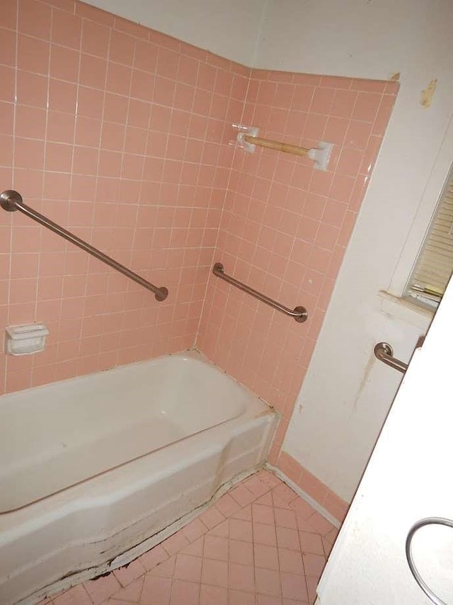 bathroom with tiled shower / bath combo and tile patterned floors