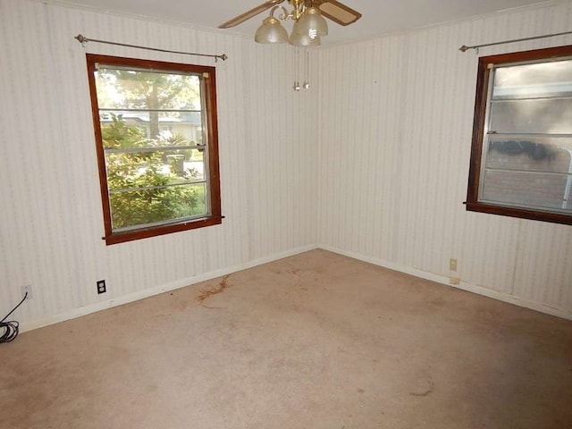 empty room featuring ceiling fan and carpet flooring