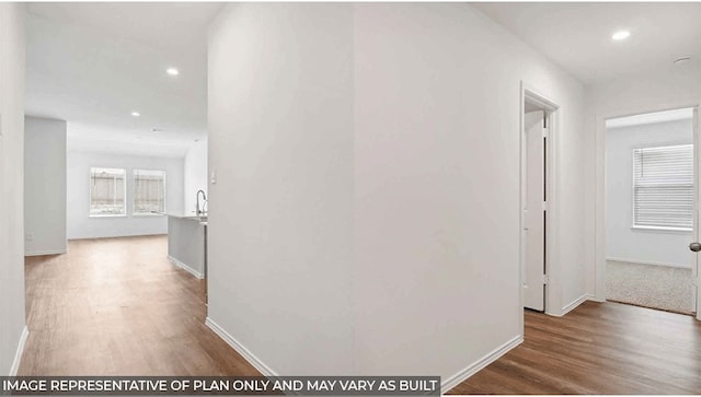 corridor with hardwood / wood-style floors