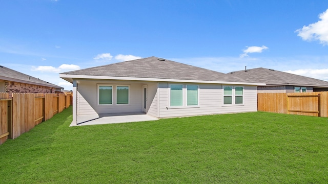 rear view of property featuring a patio area and a yard