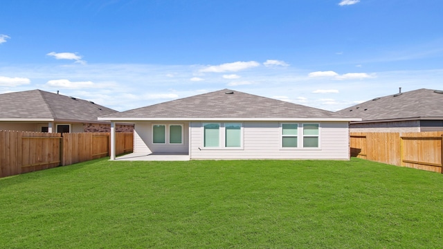 rear view of property with a patio area and a yard