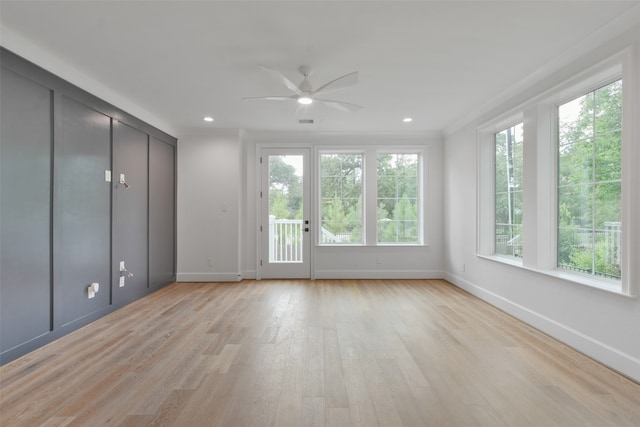 interior space with ceiling fan, light wood-type flooring, and a wealth of natural light