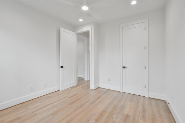 unfurnished bedroom with ceiling fan and light wood-type flooring