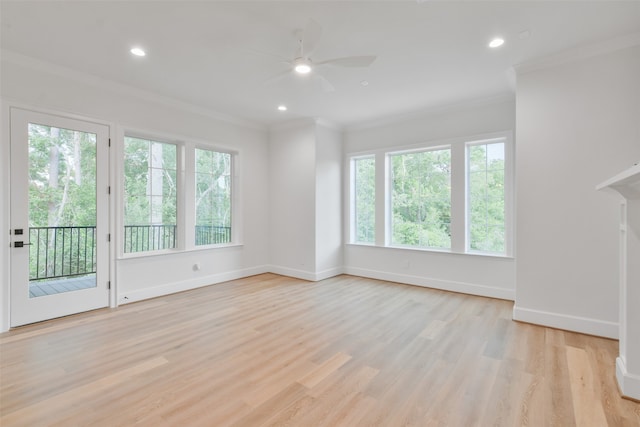 unfurnished living room featuring ceiling fan, light wood-type flooring, and ornamental molding