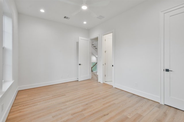 unfurnished room with ceiling fan and light hardwood / wood-style floors