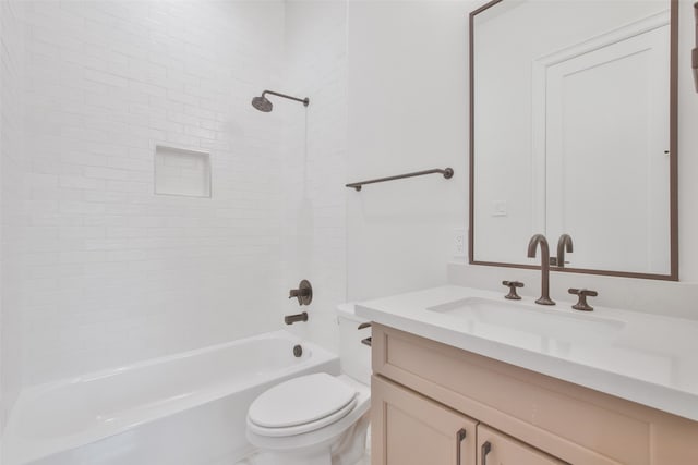 full bathroom with toilet, vanity, and tiled shower / bath