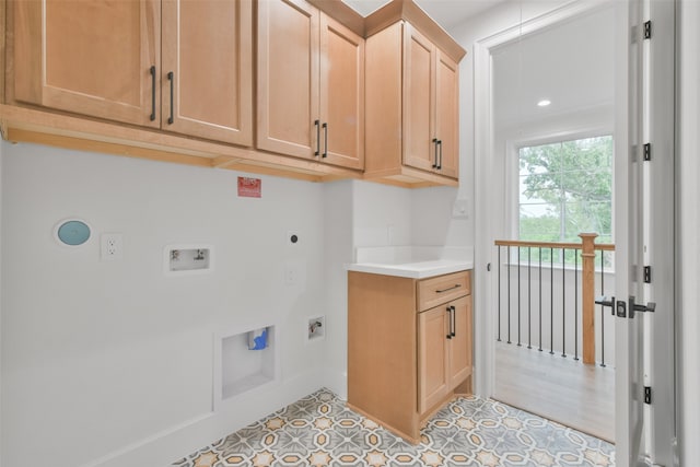 clothes washing area with light tile patterned flooring, washer hookup, hookup for an electric dryer, and cabinets