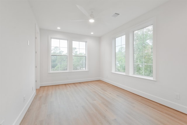 unfurnished room featuring ceiling fan, plenty of natural light, and light hardwood / wood-style floors