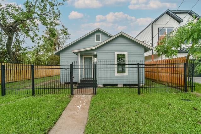 bungalow-style home featuring a front lawn