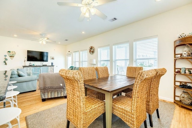 dining area with ceiling fan and light hardwood / wood-style floors