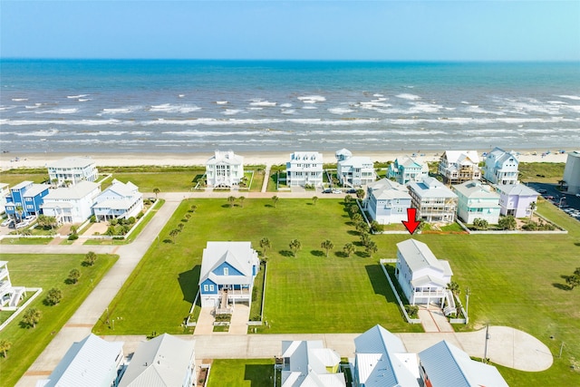 birds eye view of property with a beach view and a water view