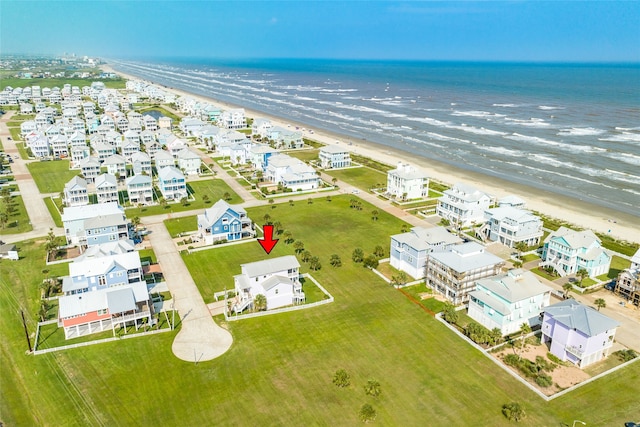 birds eye view of property with a beach view and a water view