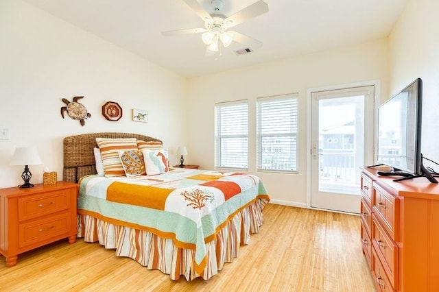 bedroom with ceiling fan, access to exterior, multiple windows, and light wood-type flooring