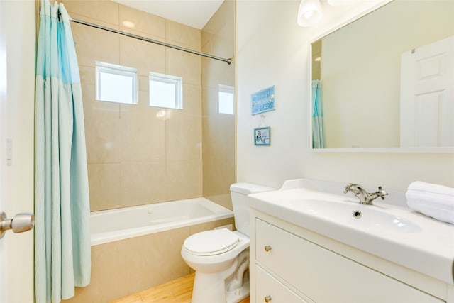 full bathroom featuring vanity, wood-type flooring, toilet, and shower / bath combo with shower curtain