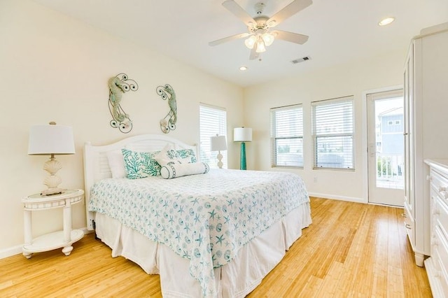 bedroom featuring ceiling fan, light hardwood / wood-style flooring, and access to outside