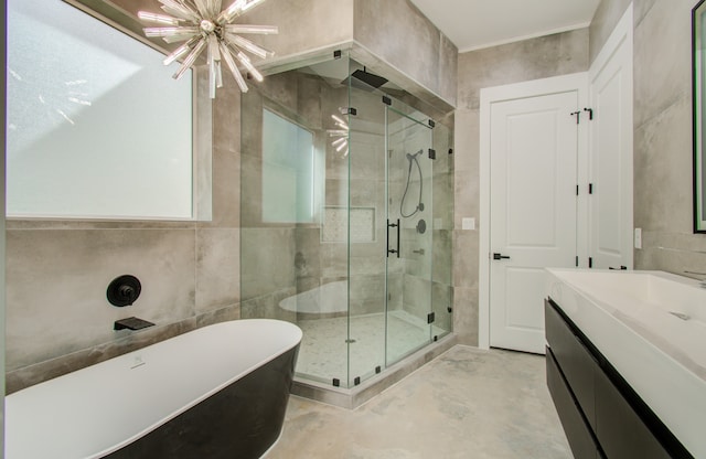 bathroom featuring vanity, shower with separate bathtub, tile walls, and a chandelier