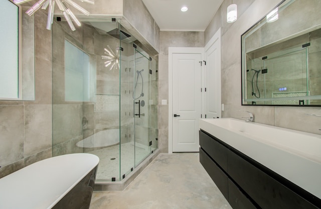 bathroom featuring vanity, separate shower and tub, and tile walls