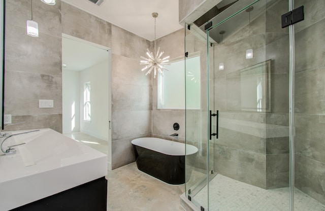 bathroom with vanity, an enclosed shower, tile walls, and a chandelier