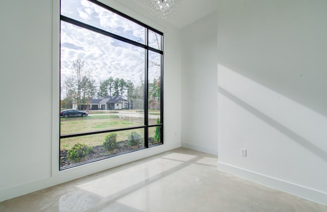 unfurnished room featuring a notable chandelier