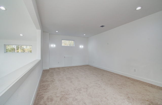 unfurnished room with light carpet