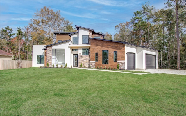 contemporary home with a garage and a front yard