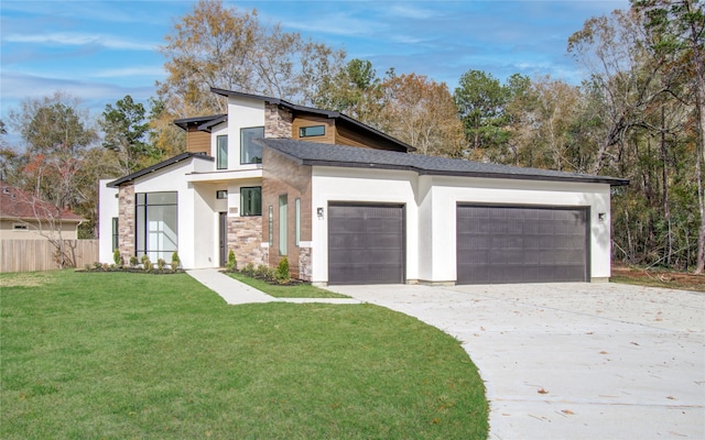 view of front of property featuring a garage and a front lawn