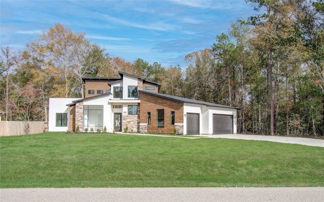 contemporary house featuring a garage and a front yard