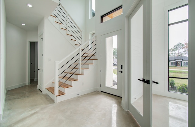 entrance foyer with french doors and a healthy amount of sunlight