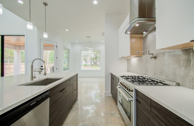 kitchen featuring dark brown cabinets, exhaust hood, light stone countertops, appliances with stainless steel finishes, and sink