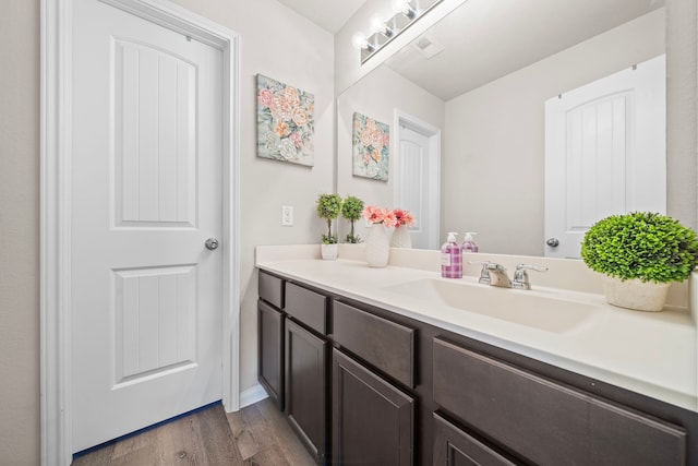 bathroom featuring vanity and hardwood / wood-style floors