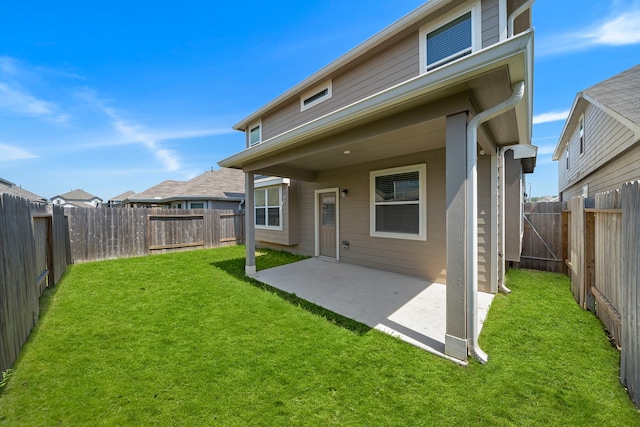 rear view of house featuring a patio and a yard