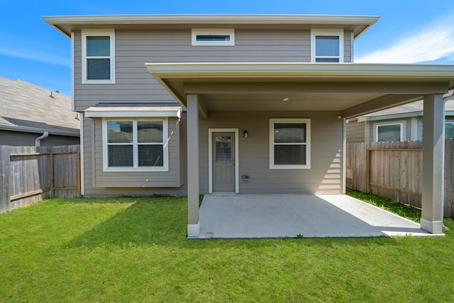 rear view of house featuring a yard and a patio area