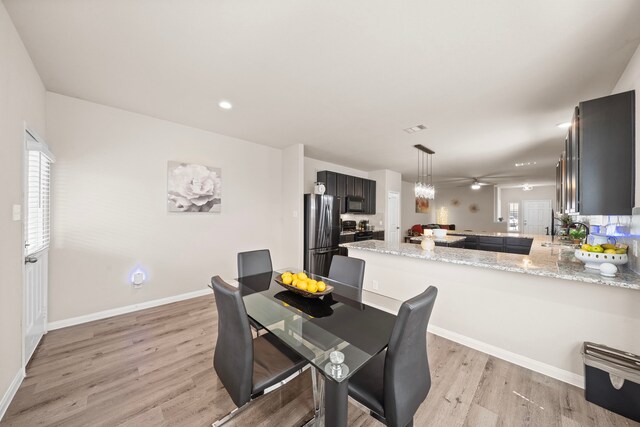 dining room with sink and light wood-type flooring