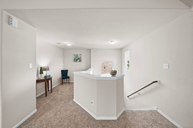 hallway featuring light carpet