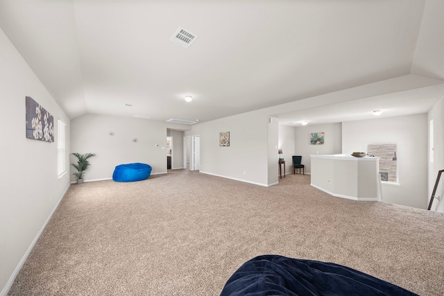 recreation room with light colored carpet and vaulted ceiling