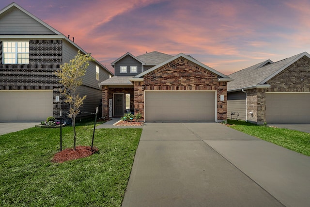 view of front facade featuring a garage and a lawn