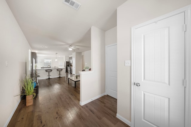 hallway with dark hardwood / wood-style flooring