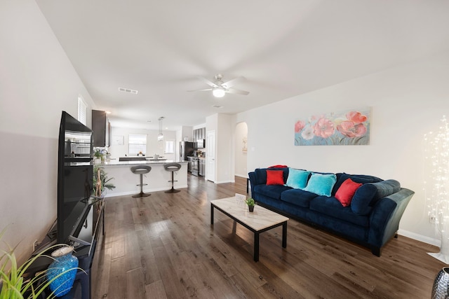 living room with hardwood / wood-style flooring and ceiling fan