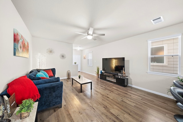 living room with wood-type flooring and ceiling fan