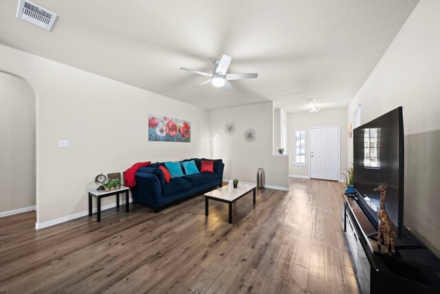 living room with hardwood / wood-style flooring and ceiling fan