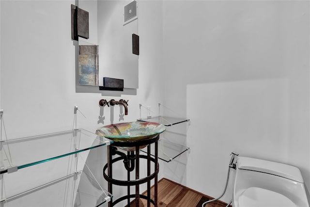 interior space featuring wood-type flooring and toilet