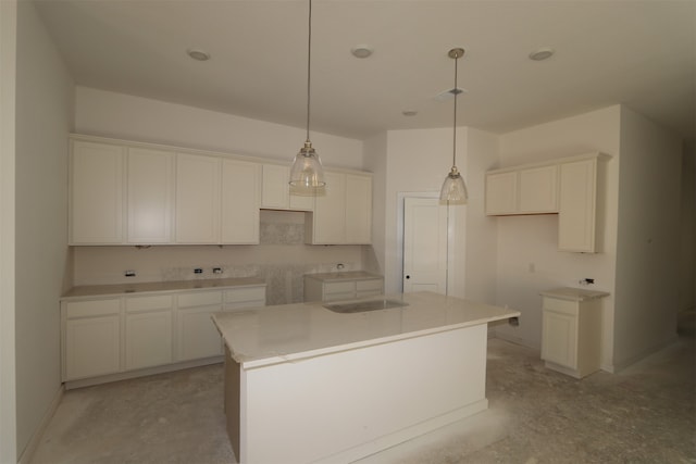 kitchen featuring white cabinets, hanging light fixtures, and a center island