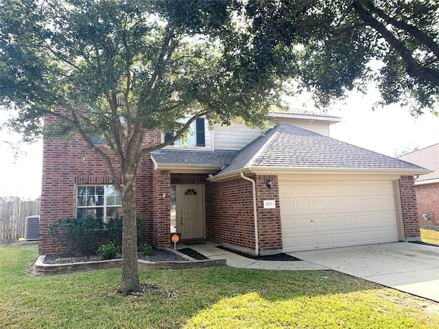 front of property featuring cooling unit, a garage, and a front yard