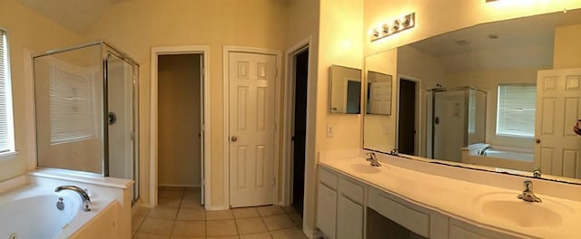 bathroom with tile patterned floors, separate shower and tub, double sink vanity, and lofted ceiling