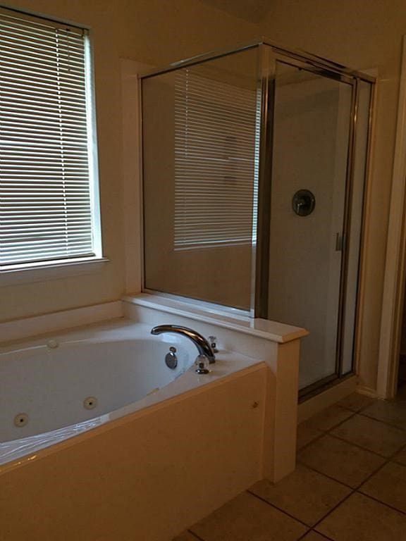 bathroom featuring plus walk in shower and tile patterned floors