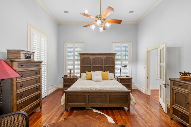 bedroom with crown molding, ceiling fan, and dark hardwood / wood-style flooring