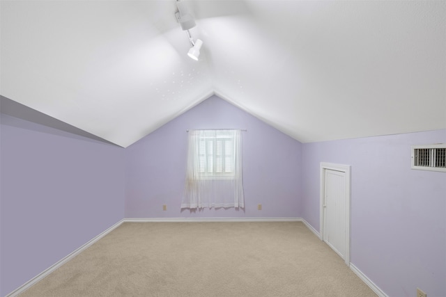 bonus room featuring lofted ceiling and light carpet