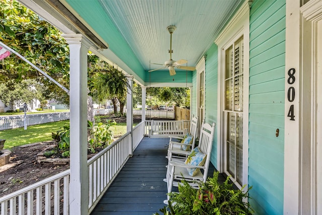 exterior space featuring a lawn, covered porch, and ceiling fan