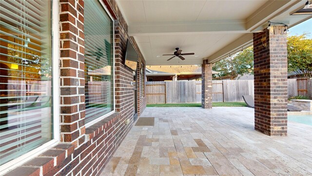 view of patio featuring ceiling fan